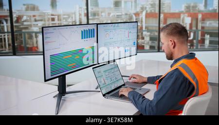 Engineer Oversees Automated Computer Systems Managing Gas And Oil Production Processes Stock Photo