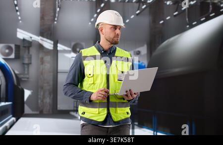 Engineer Oversees Gas Turbine Operations At Power Plant Control Room Stock Photo