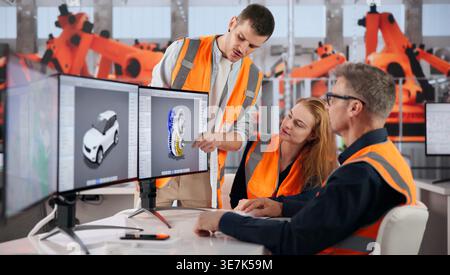 Automotive Engineer Uses Computer Software To Examine Car Design Details Closely. Stock Photo