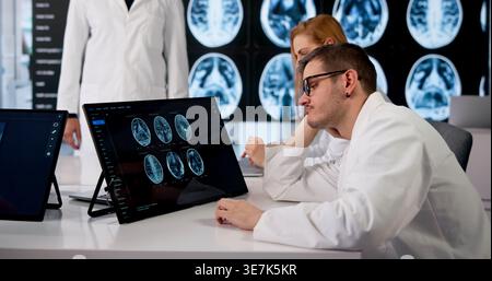 Doctor Feeling Tired And Bored During Long Neurology Training Session. Stock Photo