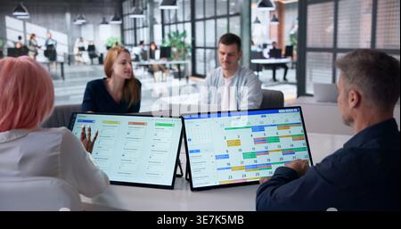 Project Manager Leading Diverse Team Discussion Using Kanban And Calendar Tools. Stock Photo