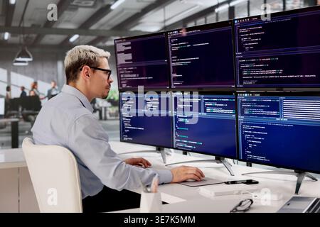 Hispanic Software Engineer Concentrating On Building Innovative Web Apps At His Workspace Stock Photo