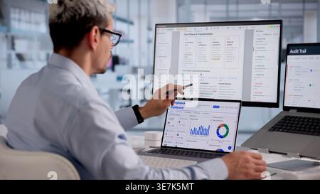 Hispanic Man Reviewing And Approving Documents With Cloud-Based Checklist On Laptop Stock Photo