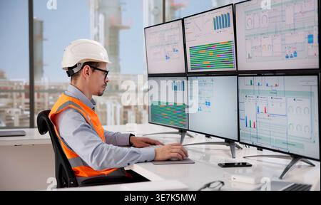 Engineer Oversees Automated Computer System Managing Gas And Oil Power Plant Operations Stock Photo