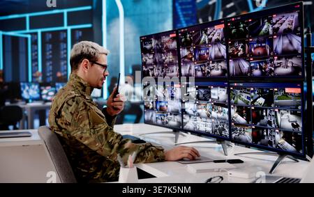 Military Analyst Overseeing Satellite Intelligence Systems In Secure Operations Center Stock Photo