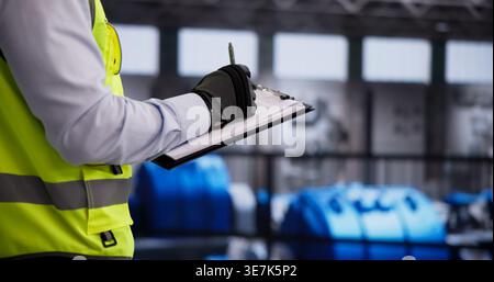 Safety Helmet-Wearing Engineer Conducts Detailed Inspection Of Gas Turbine Operation Stock Photo