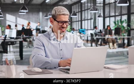 Frustrated Businessman Shutting Laptop Amid Cyber Attack Stress Stock Photo