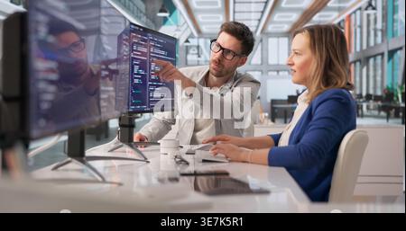 Tech Professional Collaborates On Programming To Create Innovative Solutions Stock Photo