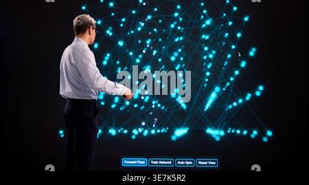 AI Training Supervision By Software Engineer On Interactive Display In Modern Office Environment Stock Photo