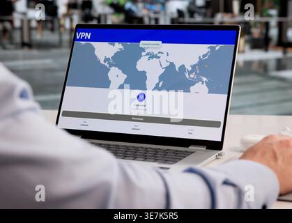 Hispanic Man Using VPN To Boost Online Privacy And Cybersecurity Protection Stock Photo