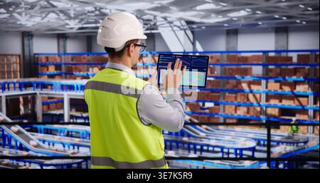 Warehouse Supervisor Reviews Inventory Metrics On Digital Tablet In Logistics Center Stock Photo