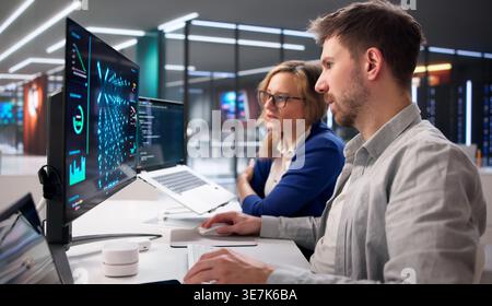 AI Specialist Supervises Machine Learning Inference On Cloud Servers In Data Center Environment Stock Photo
