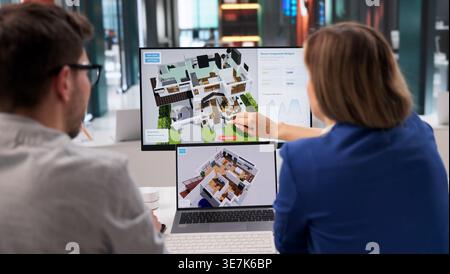 Architect Examines 3D Home Model On Computer For Renovation Plan Stock Photo