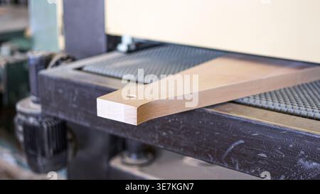 Precision woodworking machinery sanding timber component in workshop Stock Photo