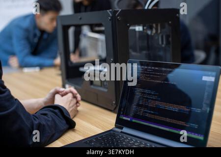 Chinese IT experts using 3D printer in office Stock Photo