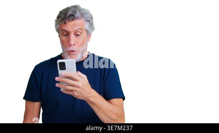 Senior man showing surprise using a smartphone Stock Photo