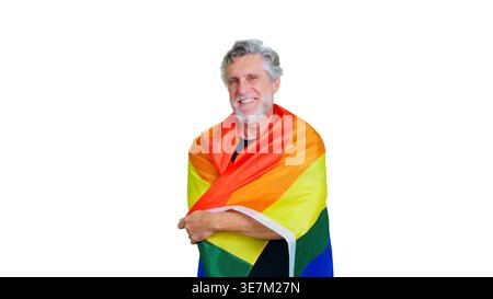 Senior man smiling, embracing rainbow pride flag Stock Photo