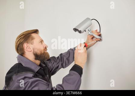 Focused Technician Installing Cctv At Home Or Office Stock Photo