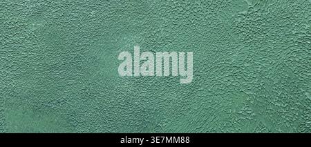 Textured turquoise painted wall surface with cracked weathered paint and rough pattern Stock Photo