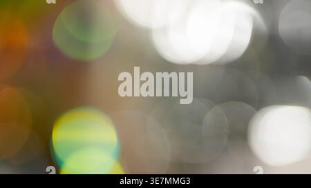Abstract bokeh background with colorful blurred light circles on gray and brown Stock Photo