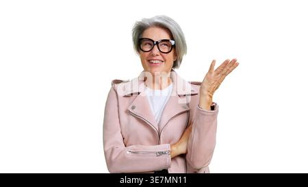 Senior woman smiling gesturing presenting isolated white background Stock Photo