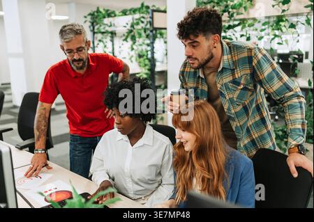 Group of business people discussing project plan using computer and analyzing chLifestyle working together in office Stock Photo