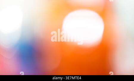 Soft abstract orange bokeh background with large white light circle and blue accent Stock Photo