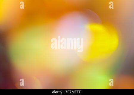 Warm yellow and orange abstract bokeh background with glowing light circles on blurred backdrop Stock Photo