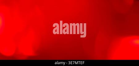 Abstract blurred red background with deep crimson bokeh glow and dark vignette Stock Photo