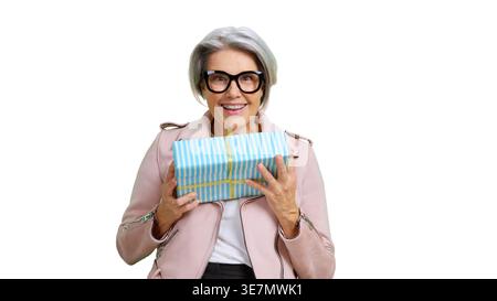 Senior woman holding gift gift box celebrating Stock Photo