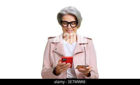 Senior woman shopping online using smartphone and credit card Stock Photo