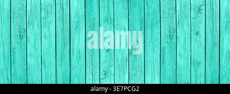 Old wooden boards with cracked peeling light teal color paint. Pastel aquamarine grunge rustic texture. Vertical aged turquoise wood plank background Stock Photo