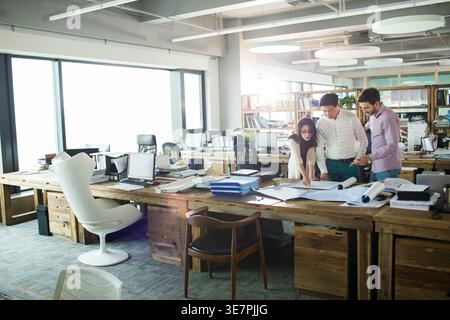 Diverse group of architects working together in office Stock Photo