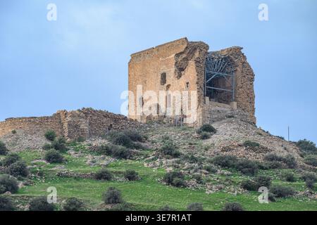 Exterior daytime shot of the Castle  of Castell de Ferro ruins displaying visible stone masonry and modern metal reinforcement on a hilltop in Andalus Stock Photo