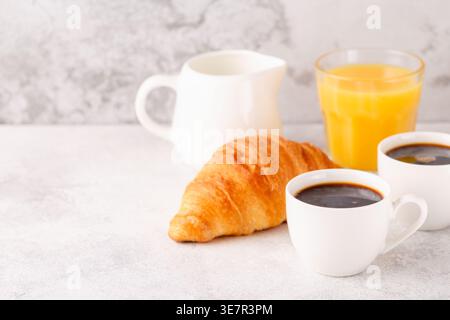Hot coffee, croissants on a light background, selective focus. Breakfast concept Stock Photo