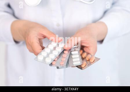 Close up of hands holding various blister packs with pills, pharmaceutical and healthcare concept Stock Photo