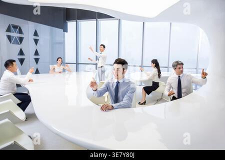 Chinese business people using advanced touch screen technology in office Stock Photo