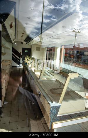 Empty shelves of closed down bakery UK Stock Photo