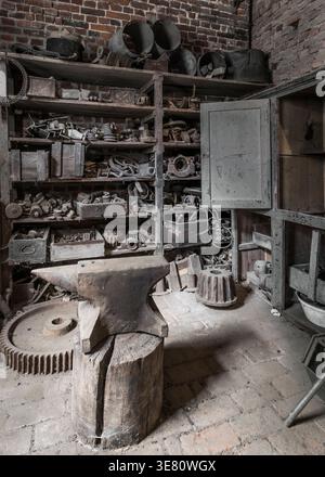 Historic anvil in a abandoned workshop. Stock Photo