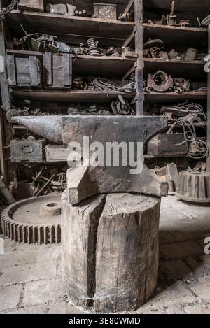 Historic anvil in a abandoned workshop. Stock Photo