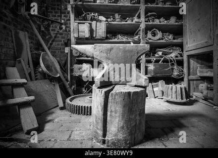 Historic anvil in a abandoned workshop. Stock Photo