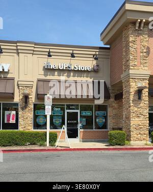 The UPS Store retail location with signage and storefront in shopping plaza, small business services including shipping, printing and mailbox services Stock Photo