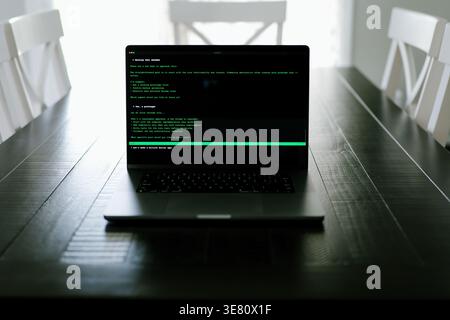 Vibe Coding Software Engineer Developing Billion Dollar Applications at Kitchen Table on Saturday Morning - AI Vibe Coder Concept Stock Photo