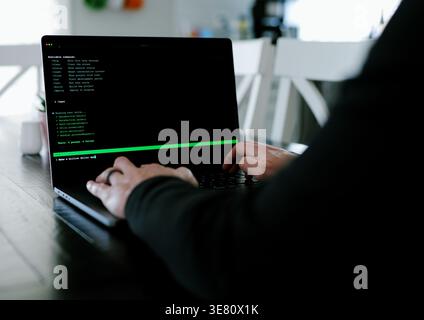 Vibe Coding Software Engineer Developing Billion Dollar Applications at Kitchen Table on Saturday Morning - AI Vibe Coder Concept Stock Photo
