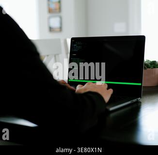 Vibe Coding Software Engineer Developing Billion Dollar Applications at Kitchen Table on Saturday Morning - AI Vibe Coder Concept Stock Photo