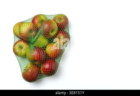 Fresh apples, red and green, packed in a green mesh bag isolated on white background Stock Photo