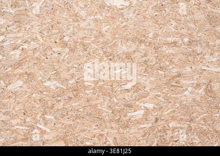High-resolution close-up of an OSB Oriented Strand Board panel. Natural wood flakes texture and pattern for construction, industrial design, and backg Stock Photo