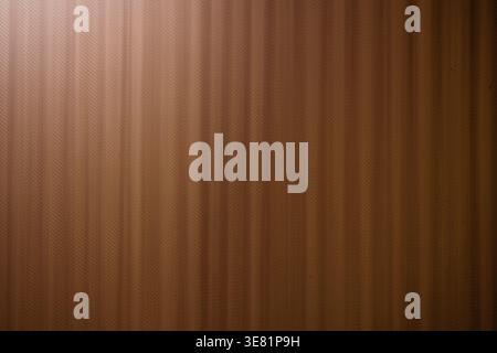 Warm wooden surface with vertical grain pattern. Soft lighting highlights texture and depth. Ideal for interiors, design, or background visuals. Stock Photo
