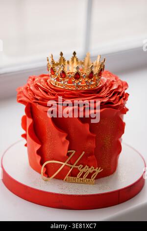 Elegant festive dessert with royal crown topper and gold lettering evoking celebration and luxury for party events Stock Photo