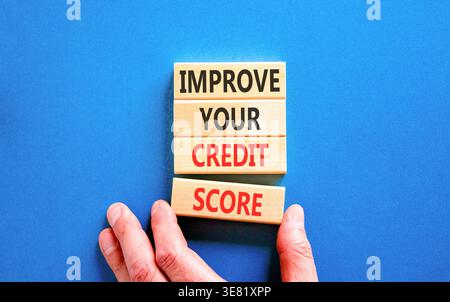 Improve your credit score words symbol. Concept words Improve your credit score on beautiful wooden blocks. Beautiful blue background. Business improv Stock Photo